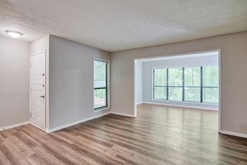 an empty living room with a large window